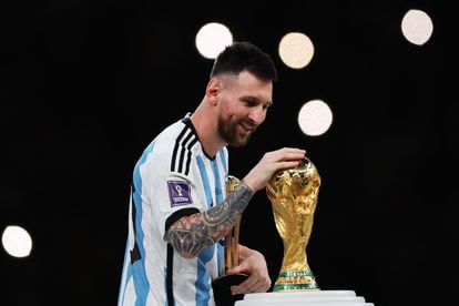 Messi caresses the World Cup in Qatar after Argentina defeated France, on December 18, 2022.