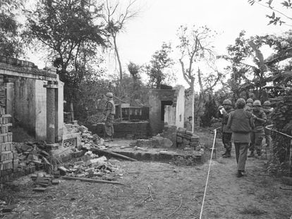 American soldiers look over the remains of a home in My Lai, South Vietnam, in this Jan. 8, 1970 file photo, two years after the massacre.