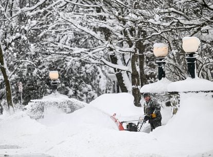 A Buffalo resident tries to shovel snow this Monday, December 26.