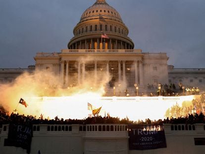 An explosion caused by a police munition is seen while supporters of Donald Trump riot in front of the US Capitol Building in Washington January 6, 2021.
