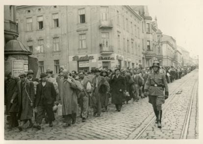 A German officer escorts a convoy of prisoners along a street in Tarnów, Poland, June 1940.