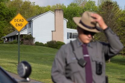 A police officer outside Payton Gendron's house in Conklin.
