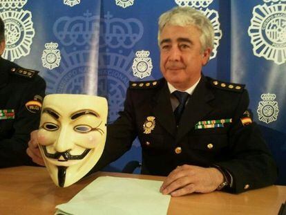 Technological brigade police chief holds up a 'V de Vendetta' mask.