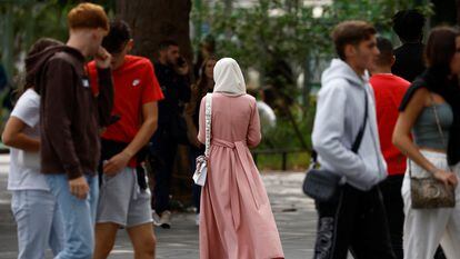 A Muslim woman wears an ankle-length tunic in a street in Nantes, France on August 29, 2023.
