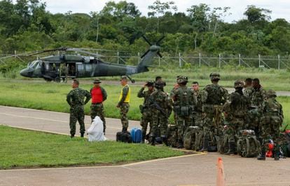 Soldiers prepare to board a helicopter headed to the search area for the missing children.