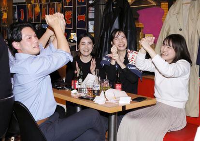 Japanese team supporters gesture as Team Japan scored in the third inning of the quarterfinal against Italy at the World Baseball Classic, at a sports bar in Tokyo, Thursday, March 16, 2023.