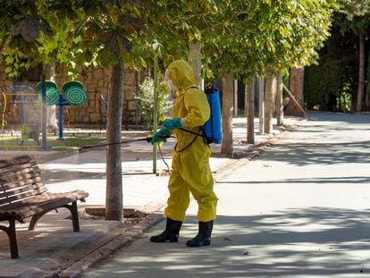 A worker disinfects an area near a senior home in Burbáguena, Teruel.