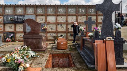 A man attends his mother’s burial, during the coronavirus outbreak in Spain.