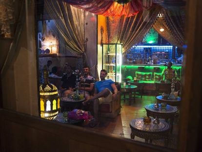 Patrons smoke a hookah in a bar in Granada, southern Spain.