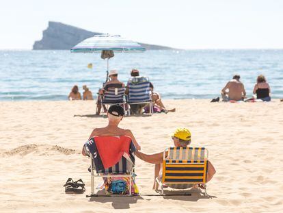 A couple sunbathes in Benidorm, Spain, in a photograph taken last March during one of the early heat waves that hit the country this year.