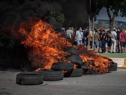 Nissan workers burn tires on Thursday to protest the announcement that the Barcelona plant will shut down in December.