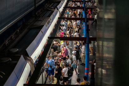 Passengers wait in line at Príncipe Pío station in Madrid.
