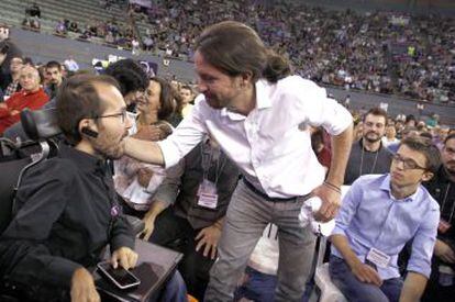 Pablo Echenique (left) is greeted by Pablo Iglesias as Iñigo Errejón looks on.