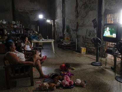 A family watches the news of the 8th Congress of the Communist Party of Cuba.