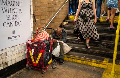 Viajeros pasan junto a un indigente en Nueva York