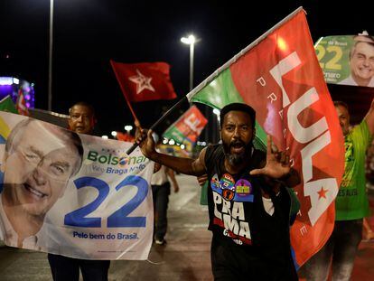 Supporters of Brazil's President and candidate for re-election Jair Bolsonaro and supporters of Brazil's former President Luiz Inacio Lula da Silva campaign together on a street during an election campaign in Brasilia.
