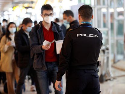 A police officer checking passenger documents at Madrid's Adolfo Suárez-Barajas Airport earlier this year.