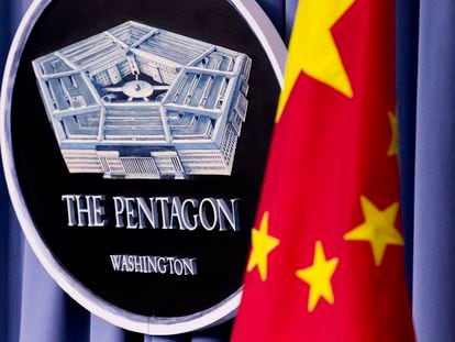 China's national flag is displayed next to the Pentagon logo at the Pentagon, on May 7, 2012.