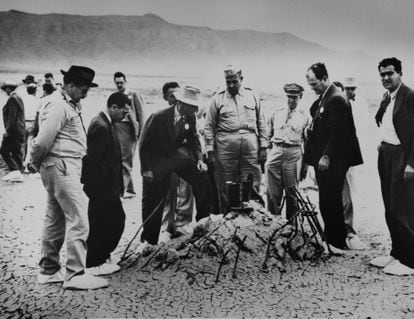 Robert Oppenheimer, general Leslie Groves and Oppenheimer inspect the remains of the tower destroyed by atomic bomb in Almogordo, New Mexico. 
