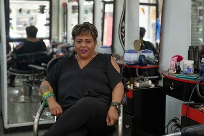 Luzmilla Arrechedera, a hair stylist, poses for a picture at the salon where she works in Caracas, Venezuela, Thursday, February 23, 2023.