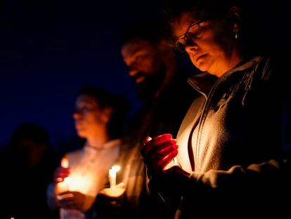 People gather at a vigil in Lisbon Falls, Maine, for victims of the week's mass shootings, Saturday, Oct. 28, 2023.