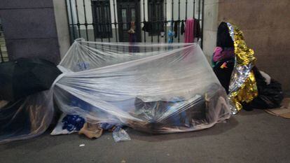 The refugees set up a makeshift tent to protect themselves from the cold.