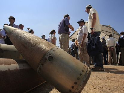 Activists and international delegations stand next to cluster bomb units, during a visit to a Lebanese military base at the opening of the Second Meeting of States Parties to the Convention on Cluster Munitions, in the southern town of Nabatiyeh, Lebanon, Sept. 12, 2011.