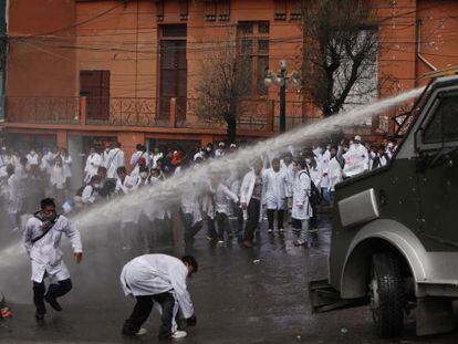 Police fire a water cannon at medical students Tuesday in La Paz.