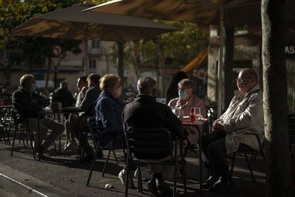 Patrons wear face masks at a sidewalk café in Barcelona on Wednesday.