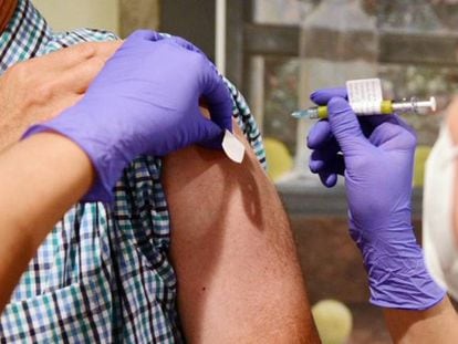 A volunteer is inoculated with the Janssen vaccine.