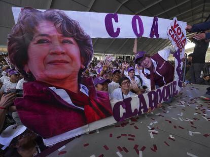 Morena political party gubernatorial candidate Delfina Gomez, right, poses with a cardboard cutout with her image during a campaign rally in Valle de Chalco, Mexico, on May 28, 2023.