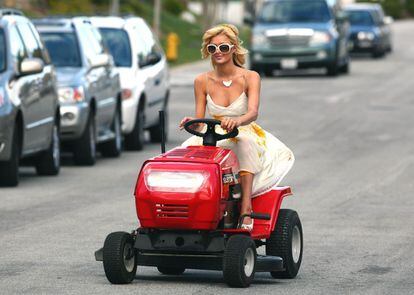 Paris Hilton on a lawnmower