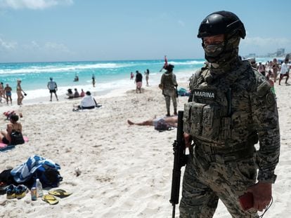 A soldier patrols Gaviota Azul beach during spring break in Cancun, Mexico.