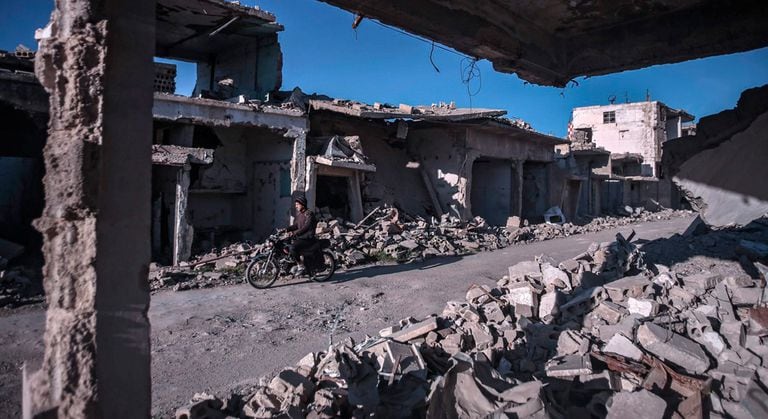 A man rides a motorbike in Duma, on the outskirts of Damascus.