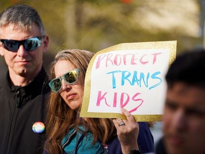 A demonstrator holds a sign during a rally after Georgia's House and Senate voted to prohibit most medical treatments to minors that help affirm gender identity, in Atlanta, Georgia, March 20, 2023.
