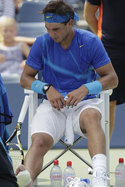 Nadal, injured and being taken care of by a physiotherapist.