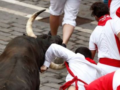 A runner gets his left arm ripped by a horn in a fast Friday morning run at the world-famous San Fermín festival