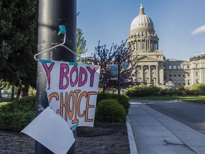 A sign reading "My body, my choice," is taped to a hanger taped to a streetlight in front of the Idaho state Capitol Building in Boise, Idaho, May 3, 2022.
