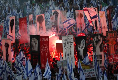 Protesters carry placards, flags and light flares as they protest outside the Israeli Supreme Court in Jerusalem, on September 11, 2023.