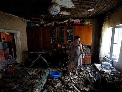 A local resident stands inside her house damaged by recent shelling in the course of Russia-Ukraine conflict in Donetsk, Russian-controlled Ukraine, on August 8, 2023.
