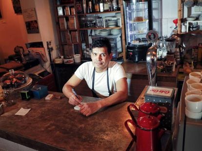Julio Grisales works long hours at his Madrid coffee bar.