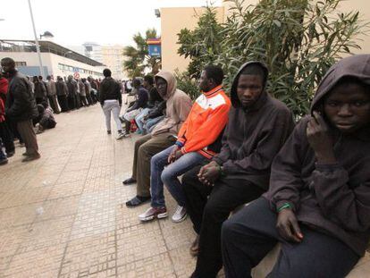 Immigrants who made it over the Melilla border fence, pictured at the police station.