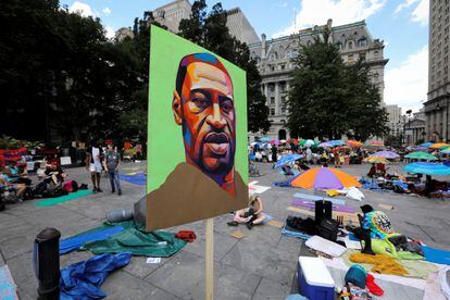 An image of George Floyd is seen at a protest to defund the police near City Hall, in New York City, New York, in June 2020.