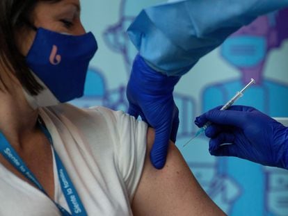 A coronavirus vaccine is administered to a senior home director in Badalona (Barcelona).