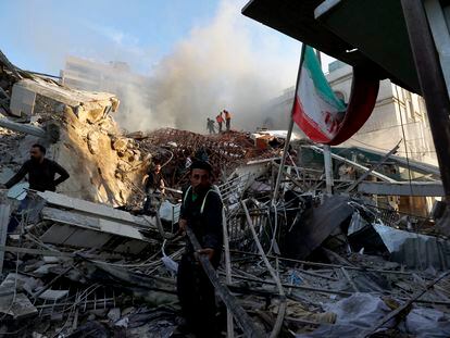 Emergency services work after the attack on the Iranian Embassy in Damascus on Monday.