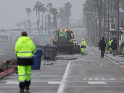 Workers begin to clean up debris from a storm, in Oceanside, California, U.S., February 6, 2024.