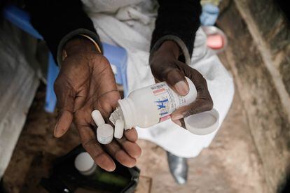 A woman taking antiretroviral HIV medication pills in Nairobi, Kenya. 