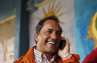Daniel Scioli speaks on his cellphone on Sunday.