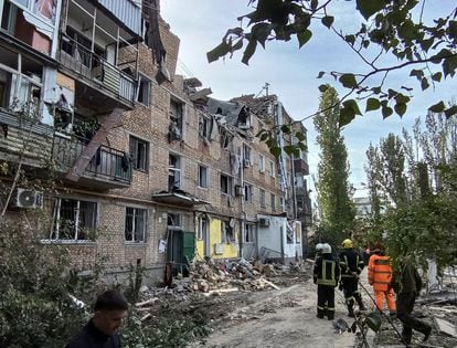 Rescuers work at the site of an apartment building damaged by a Russian military strike in Mykolaiv, October 13, 2022.  