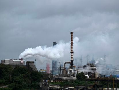 FILE - Steam emits from a crude oil refinery in Kochi, Kerala state, India, in 2022.